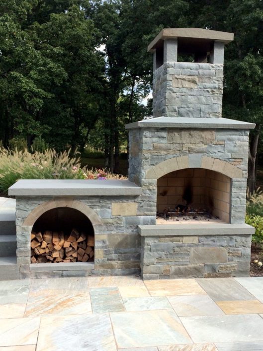 Outdoor Stone Patio Fireplace by Cording Landscape Design