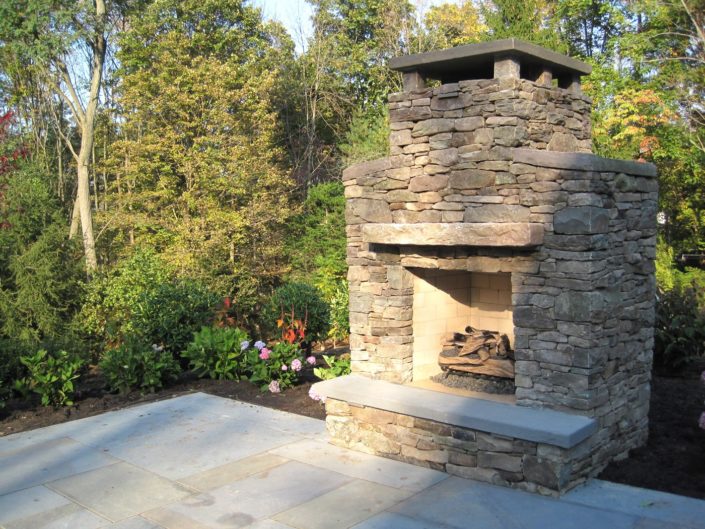 Outdoor Stone Patio Fireplace by Cording Landscape Design
